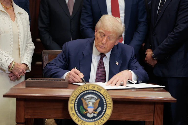 Donald Trump signing a document