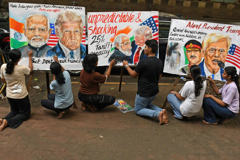 Students create painted posters protesting Trump's tariffs