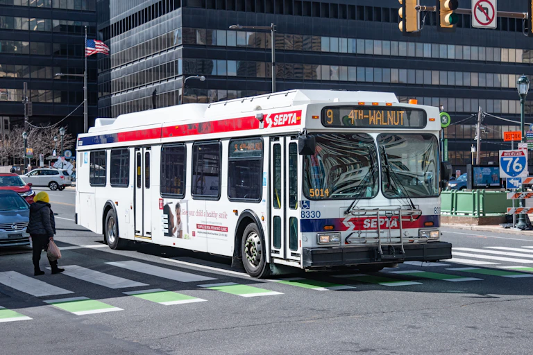 Public bus drives down a commercial corridor