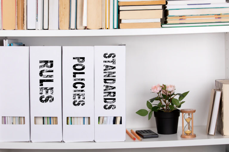 Three white folders say 'Rules,' 'Policies' and 'Standards.'