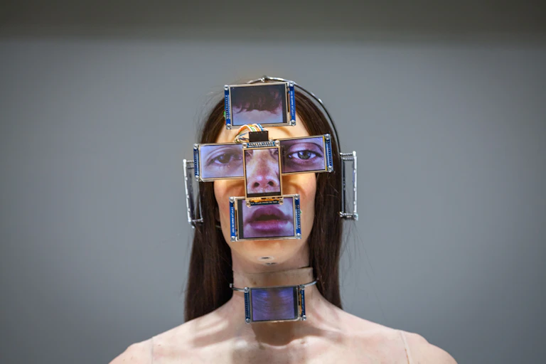 A mannequin with screens in front of its features.