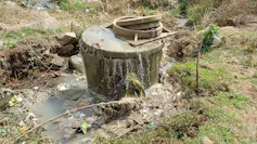 A manhole from which brown sewage is gushing out everywhere - faulty wastewater system