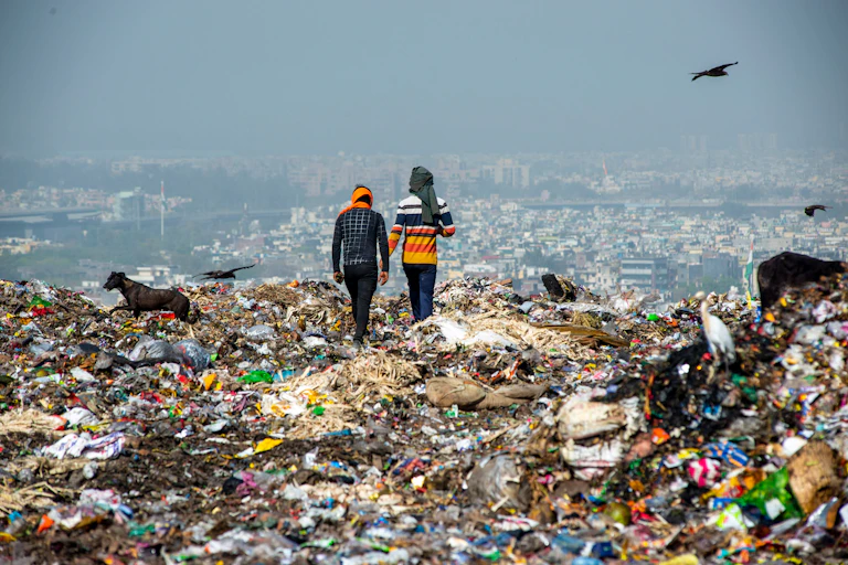 two people stood on landfill overlooking city