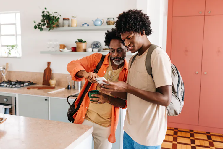 Father and son looking at phone