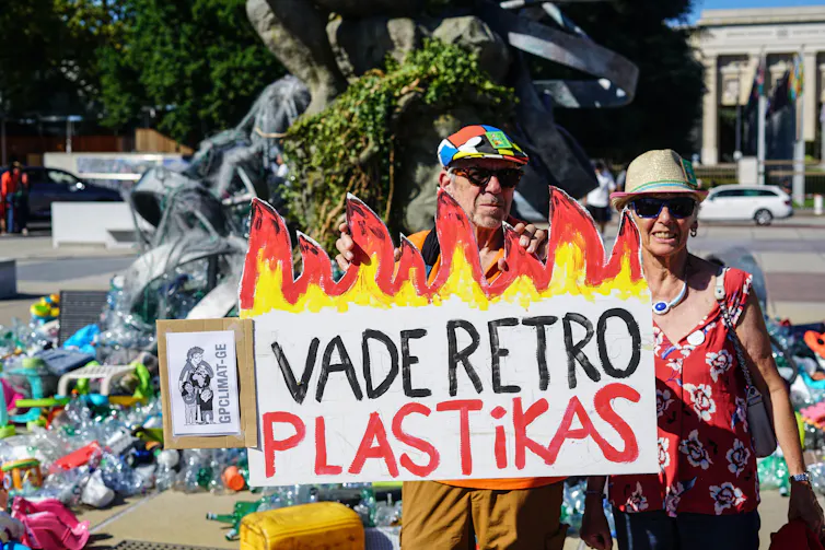 what’s at stake in the global treaty talks in Geneva 1 protesters with sign saying 'vade retro plastikas'