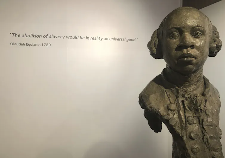 A sculpted clay bust of a man in 18th century frilly shirt and buttons.