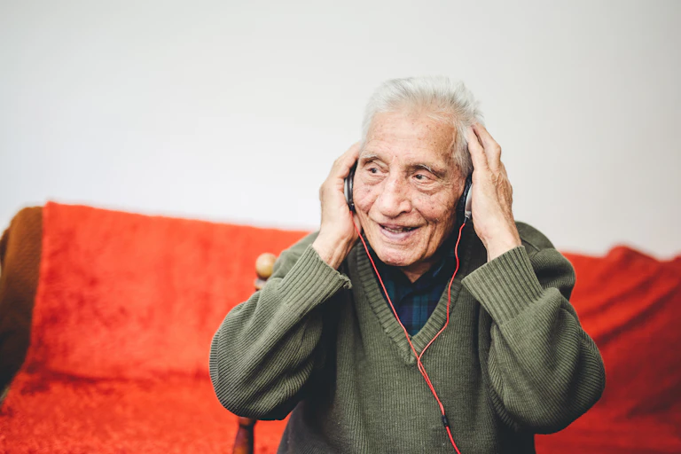 Photo of an old man wearing headphones.