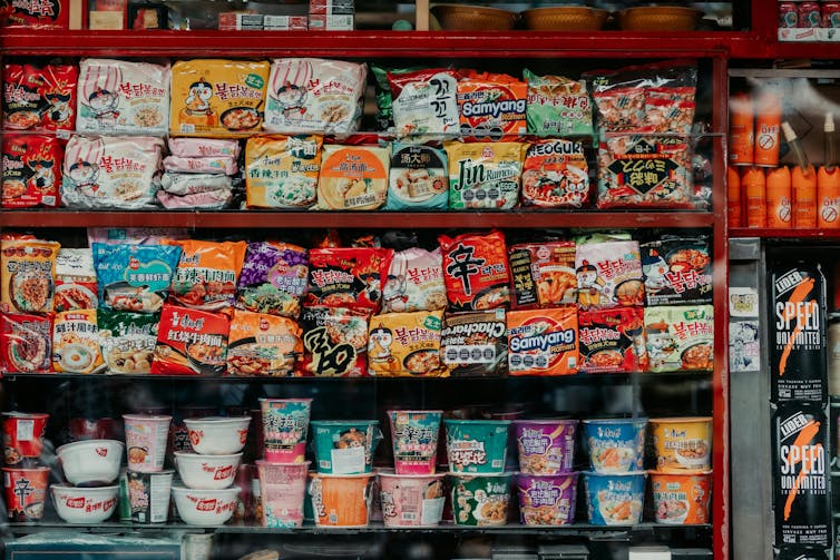 Instant noodles sit on a shelf at a shop.