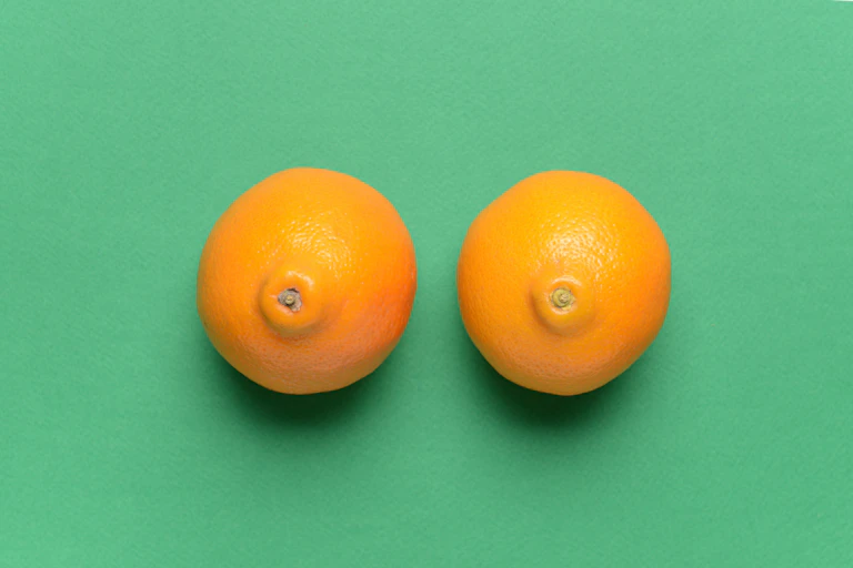 Two mandarins on a green background.