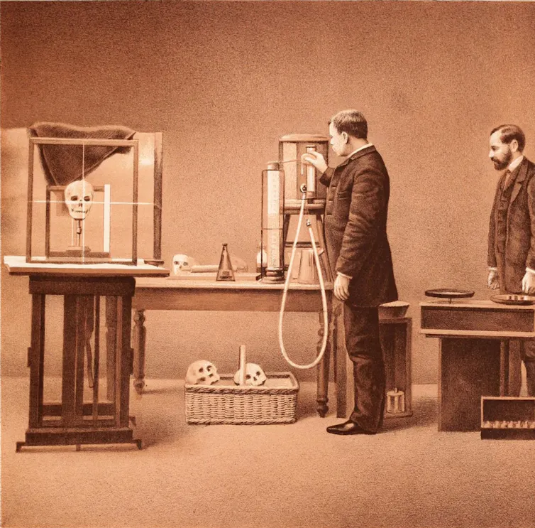 Sepia image of men conducting experiments with skulls.