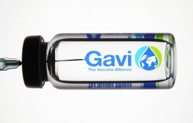 An illustration of a medical syringe emblazoned with the Gavi vaccine alliance logo and branding.