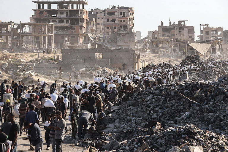 People in queues amid rubble