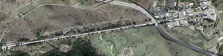 An aerial image of a very long and thin facility.