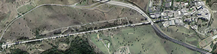 An aerial image of a very long and thin facility.