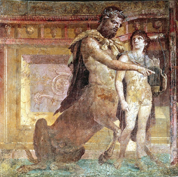 Pikturë e një centauri duke mësuar një djalë të luajë lirën.