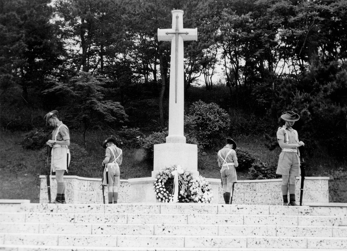 Four diggers under a cross.