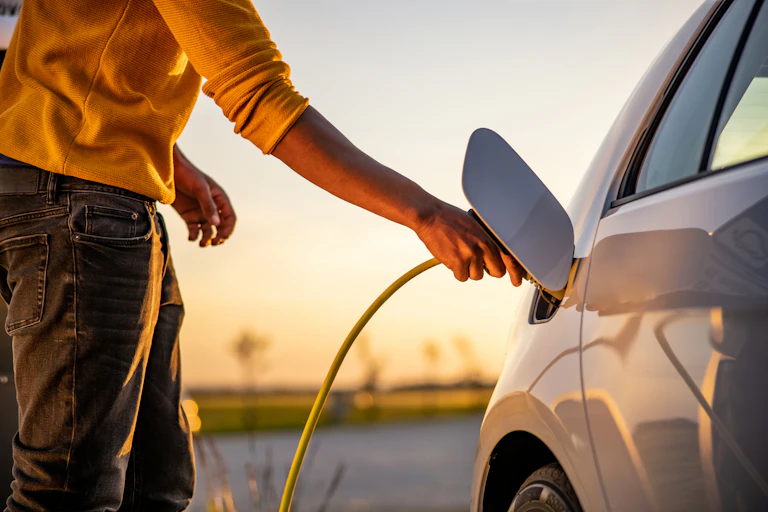 man charging EV