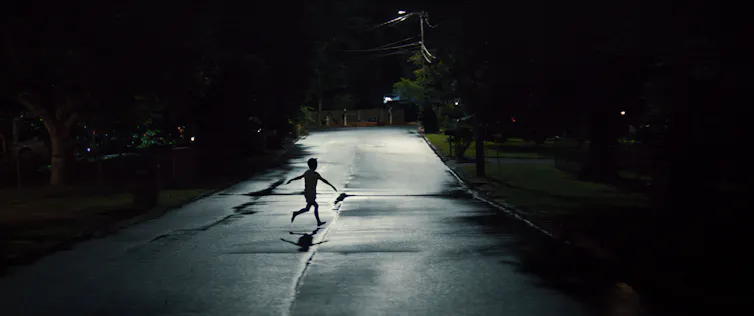 A child running in a dark street