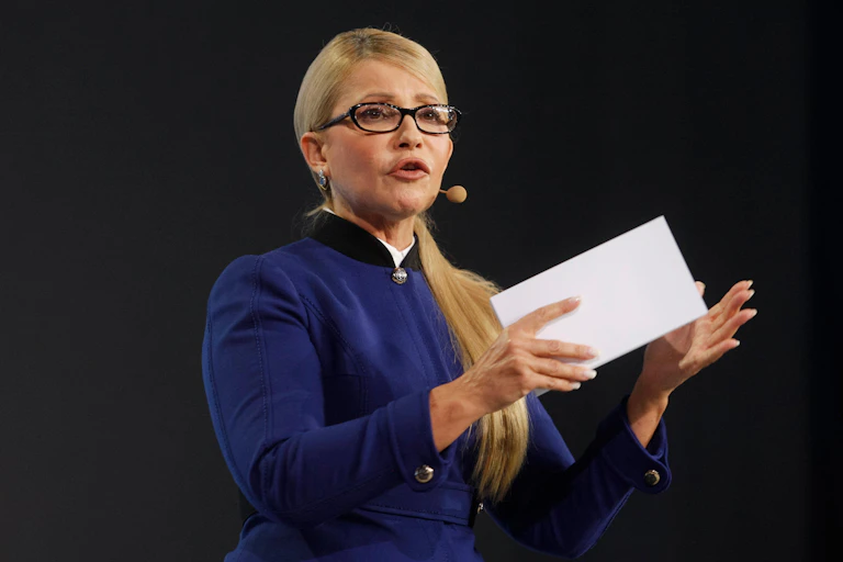 Ukraine's former prime minister Yulia Tymoshenko with a microphone and holding a piece of paper.