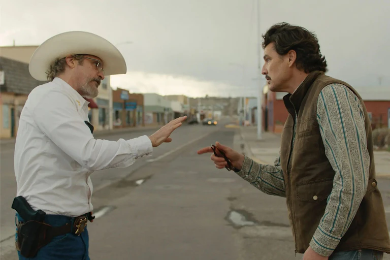 Two men stand facing one another, having an argument