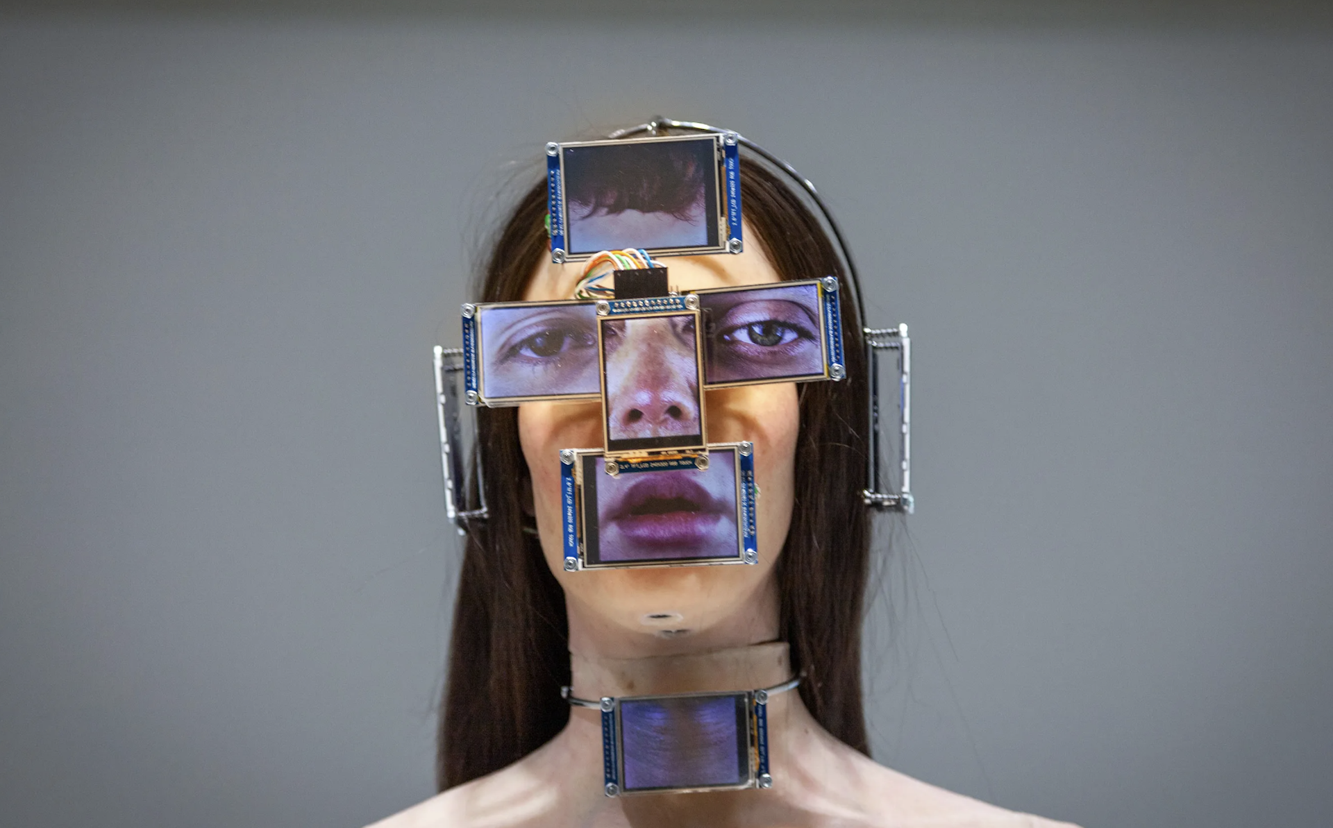A digital image of a human face that has screens for features