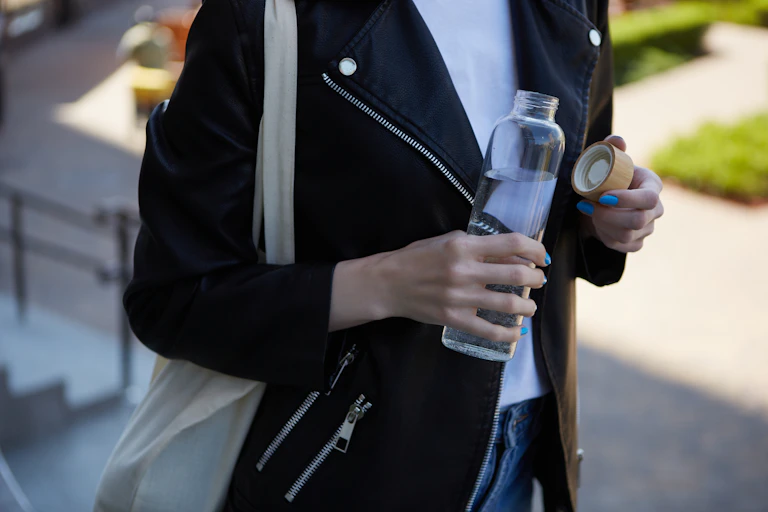 woman holding a reusable water bottle