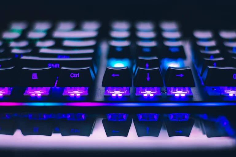 close up of a keyboard with purple backlighting
