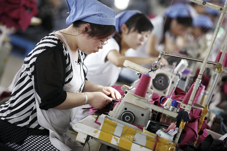 Female workers make clothes for export to Germany at a clothing factory in Huaibei, Anhui province, east China,