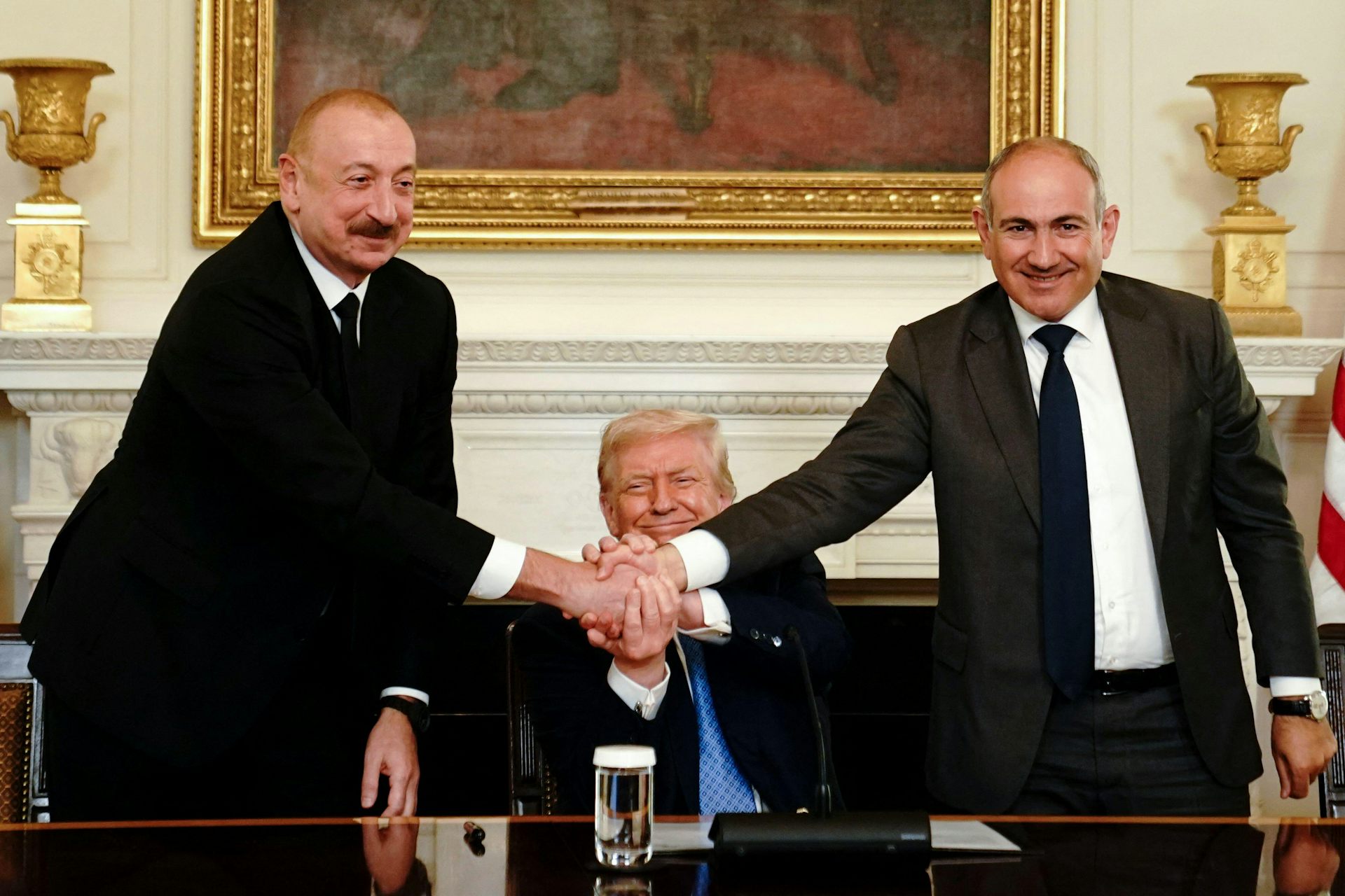 Ilham Aliyev, Donald Trump and Nikol Pashinyan join hands at the White House.