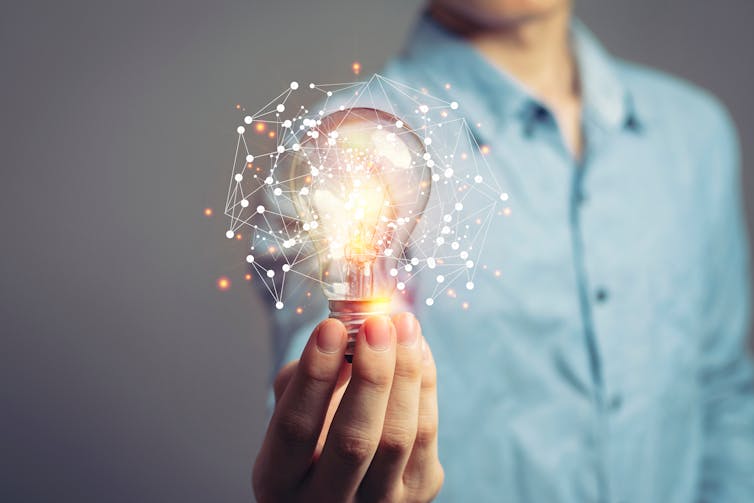 man holding lightbulb