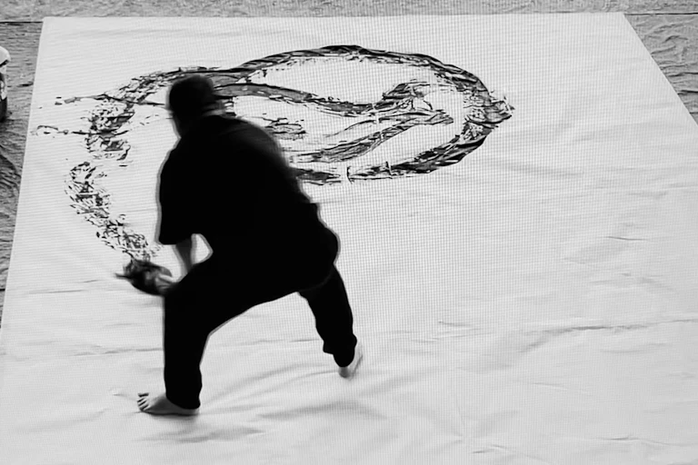 Man drawing giant Chinese character