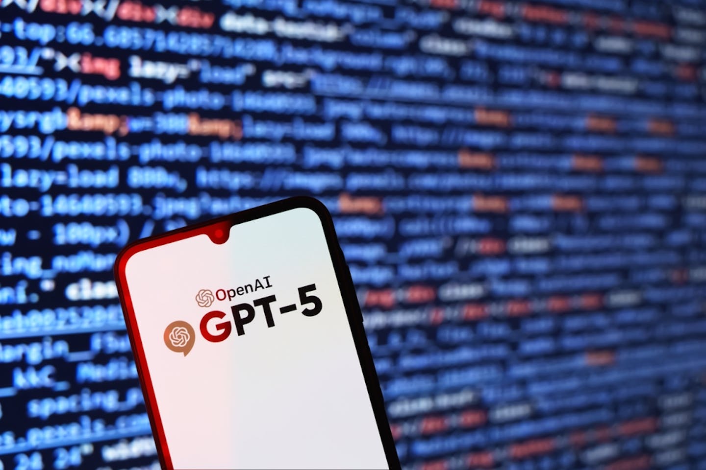 GPT-5 phone in front of a computer screen