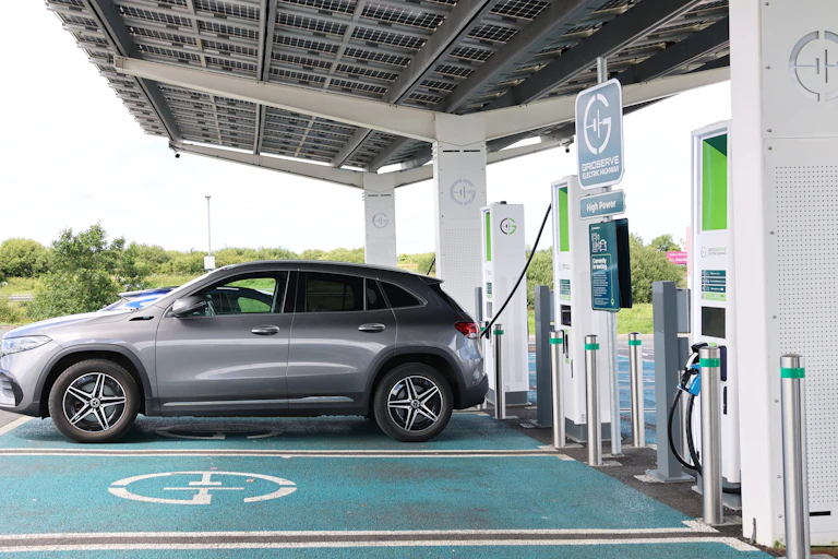 silver car at rapid charging station waiting for charge