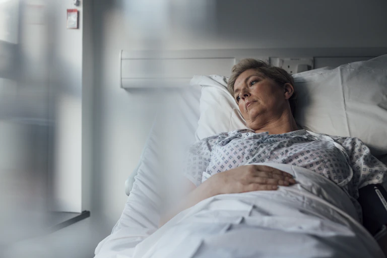 A woman lying in a hospital bed.