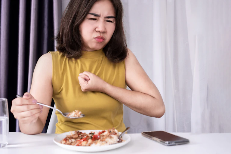 Woman with indigestion while eating