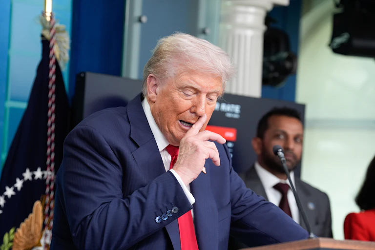 Donald Trump gestures as he addresses the media at the White House.