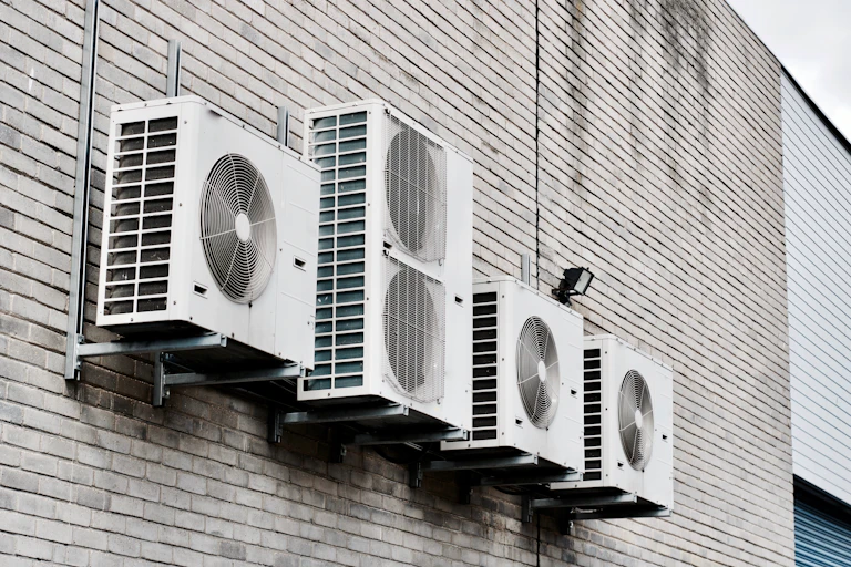 Air conditioning units mounted to a brick wall
