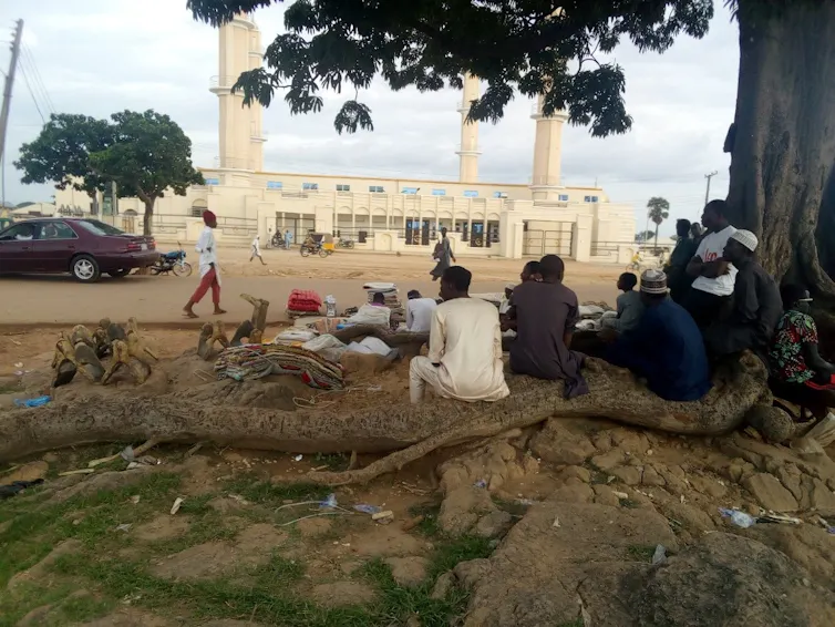 A group of people relaxing under a tree