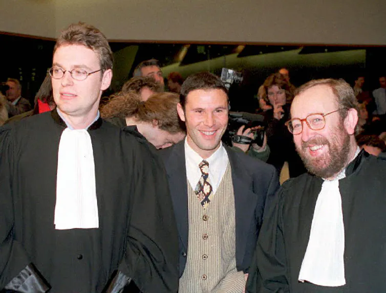 Jean-Marc Bosman, flanked by two of his lawyers, smiles after the European Court of Justice ruled in his favour on December 15, 1995.