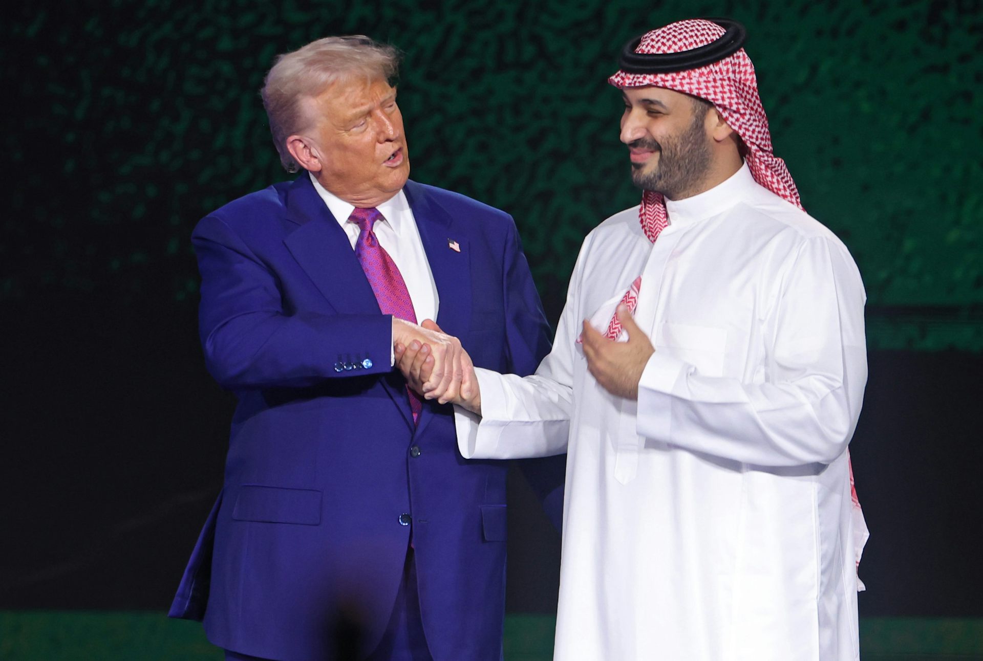 Trump shaking hands with Mohammed bin Salman.