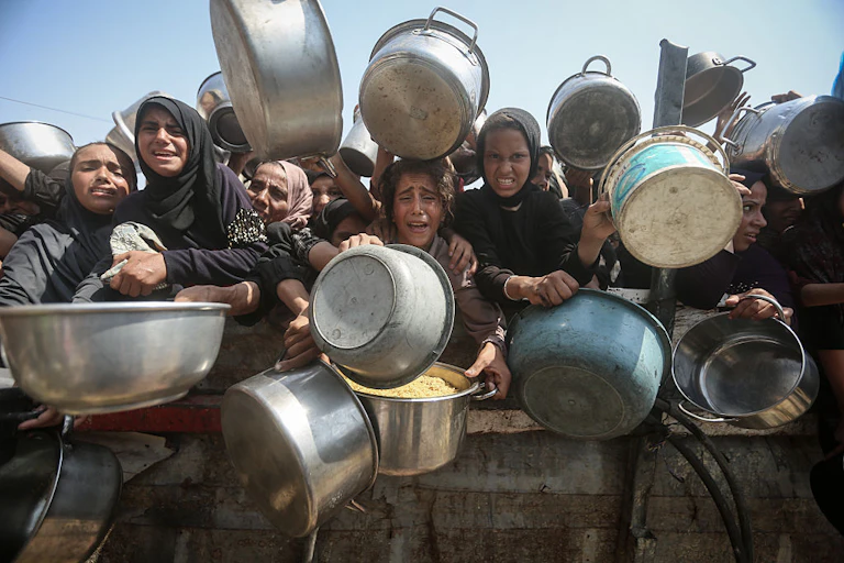Women and children holding pots