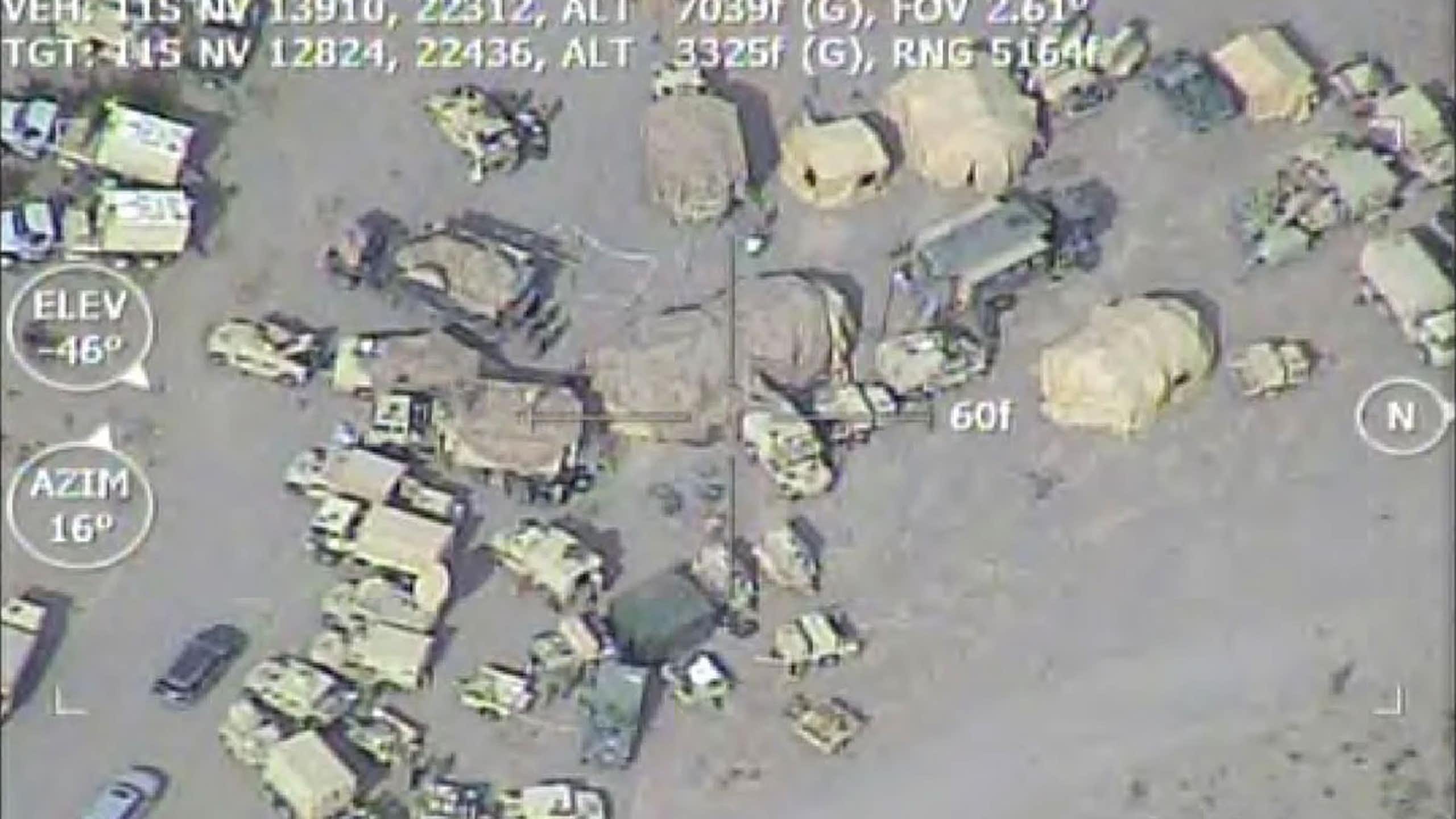 aerial view of a cluster of military vehicles in a desert