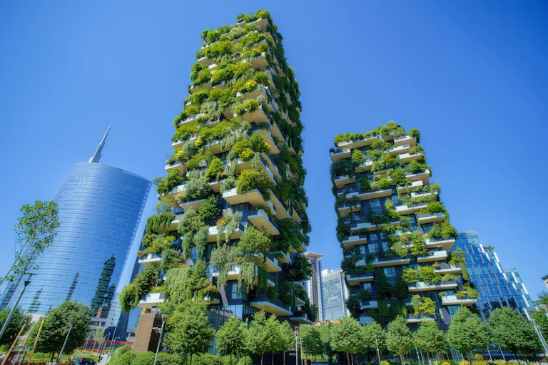 two skyscrapers covered in green plants, blue sky in city of Milan