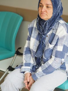 A woman is sitting on a chair