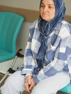 A woman is sitting on a chair