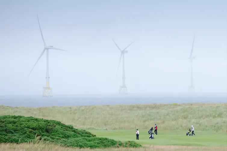 golf course with wind farm in background