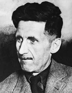 A man with a long face, thin nose and dark, wavy hair.