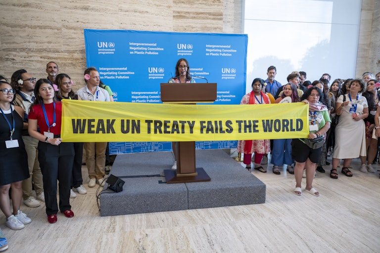Activists hold a banner that reads 'Weak UN treaty fails the world' during the last day of the Second Part of the Fifth Session of the Intergovernmental Negotiating Committee on Plastic Pollution (INC-5.2), at the European headquarters of the United Nations, Switzerland, 14 August 2025.