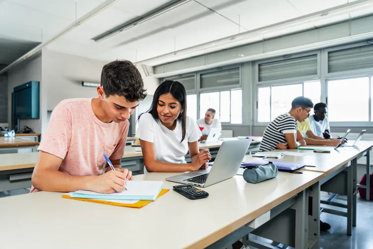 Students in class with laptop and calculator