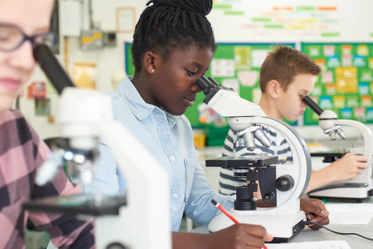 School pupils using microscopes